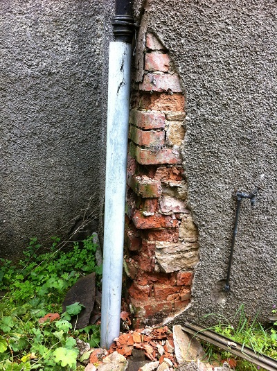 Brick decay due to leaky downpipe and cement render
